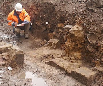 Grabungsleiter Thies Evers legt eine Detailzeichnung der Mauerreste an