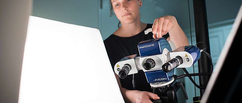 Mitarbeiterin des Zentrum für Digitale Kulturgüter in Museen (ZEDIKUM) digitalisiert eine Tontafel mithilfe eines Streifenlichtscanners
