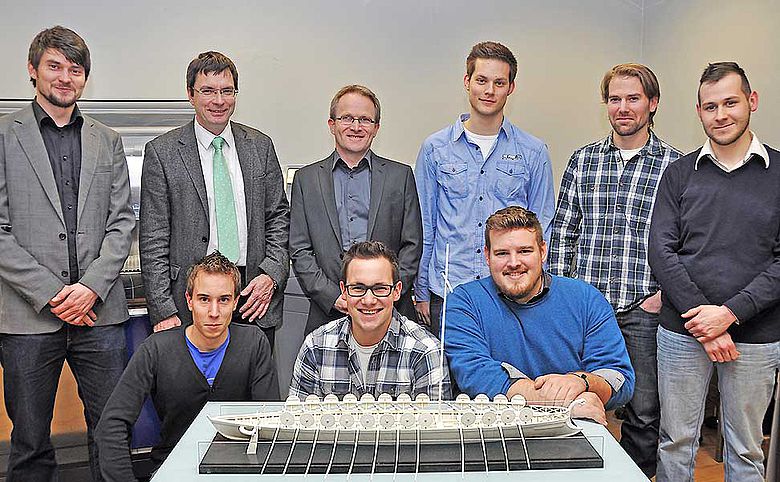 Trierer Forscher und Studenten mit Schiffsmodell
